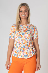 Esper printed top with tie hem and short sleeves orange and pink .